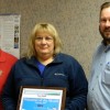 Tina Webb accepted the PRIDE Volunteer of the Month Award from PRIDE’s Mark Davis (right). They were joined by Johnson County Sheriff Dwayne Price (left), who nominated Webb for the award. Photo by the Paintsville Herald.