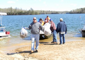 Unloading trash from boat during Laural Lake Cleanup