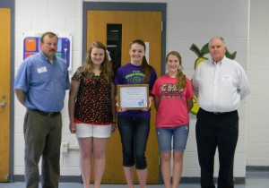 Clinton County Middle School students Jana Mullins, Chloe Martin and Olivia Maupin accepted the school’s PRIDE Environmental Education Project of the Month Award. PRIDE’s Mark Davis (left) presented the plaque, and Judge-Executive Lyle K. Huff congratulated the students on their achievement.