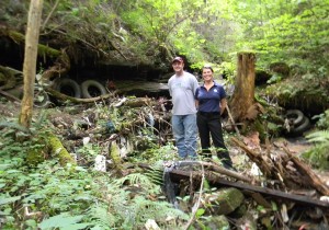 Wolfe County Solid Waste Coordinator Ashley Bowman and PRIDE President/CEO Tammie Wilson visiting one of the dump sites along Swift Camp Creek in Fall 2012. The trash was removed during a year-long cleanup that just ended.