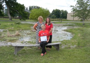 RCMS Laker PRIDE Club co-sponsors Jean Clement (seated) and Jennifer Hardwick (standing on left) accepted the PRIDE Environmental Education Project of the Month Award from PRIDE’s Jennifer Johnson.