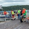 Volunteers remove trash from a boat