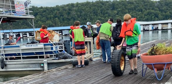 Volunteers remove trash from a boat